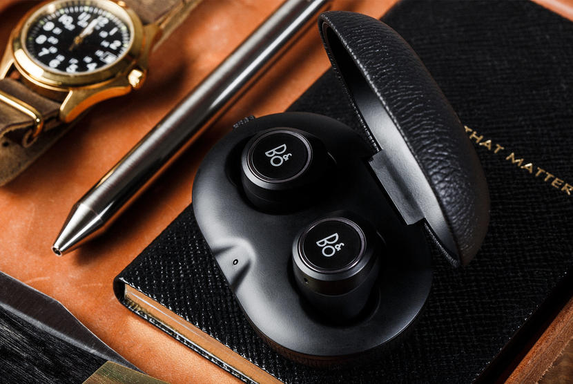 Bang & Olufsen earphones sitting in charging case.