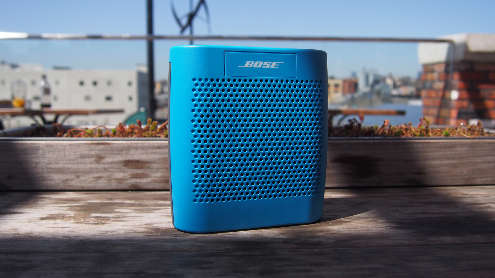 Blue Bose Bluetooth speaker sitting on counter top.