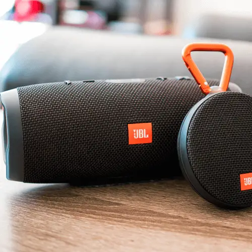 JBL portable Bluetooth speakers sitting next to each other.