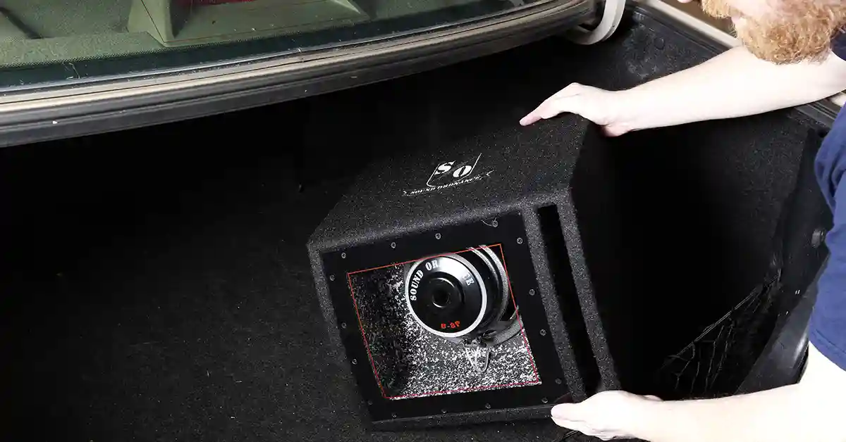 Subwoofer in the back of a car being installed