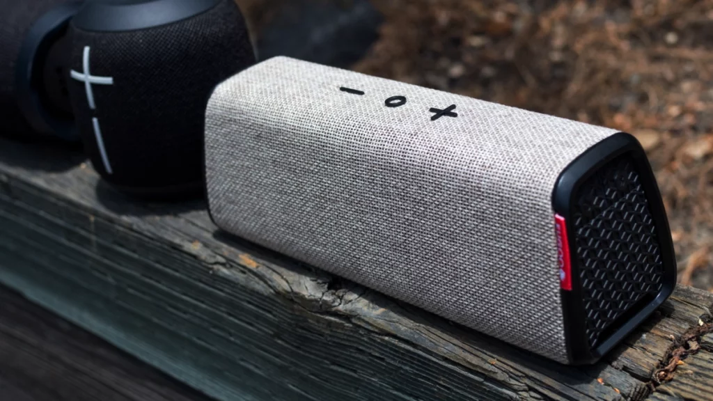 Bluetooth speaker sitting on a bench next to another speaker.